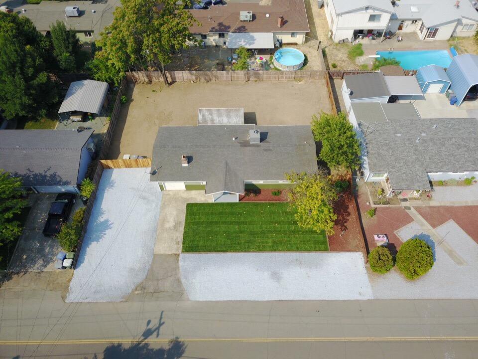 6560 Riverside Drive Redding, CA 96001 - Photo 14 of 15 an aerial view of a house with outdoor space and a parking area