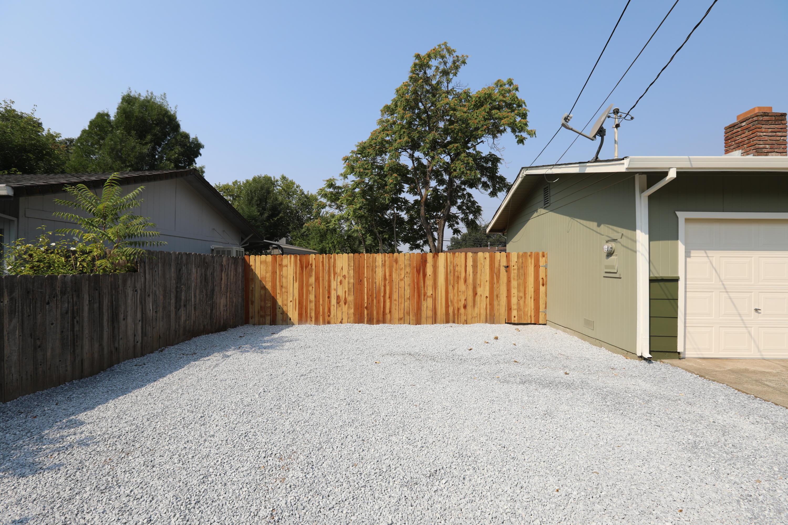 6560 Riverside Drive Redding, CA 96001 - Photo 2 of 15 a view of backyard with small cabin and wooden fencing
