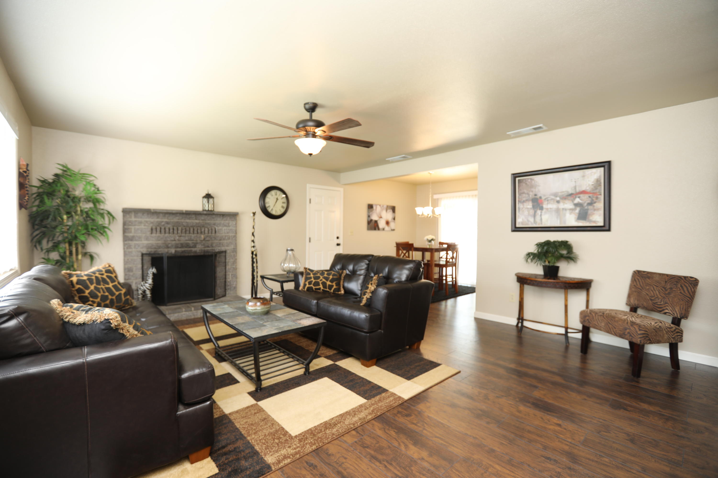 6560 Riverside Drive Redding, CA 96001 - Photo 7 of 15 a living room with furniture a fireplace and a ceiling fan