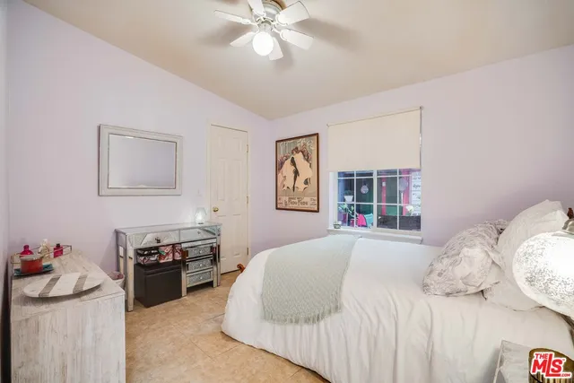 a bedroom with a bed and dresser