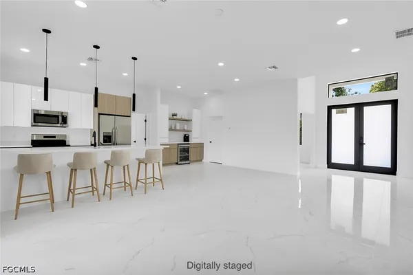 a view of kitchen with stainless steel appliances kitchen island microwave and cabinets