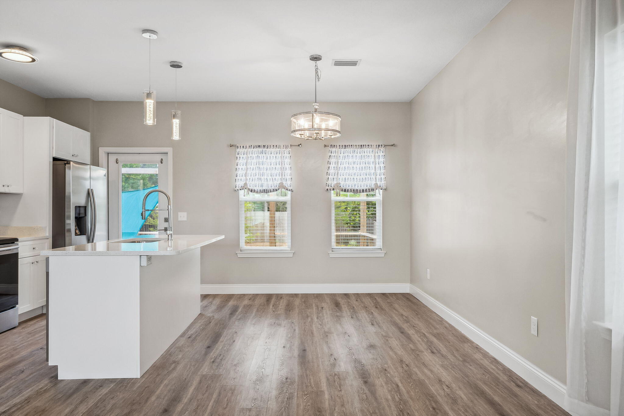 275 Indian Woman Road Santa Rosa Beach, FL 32459 - Photo 14 of 41 an empty room with wooden floor and windows