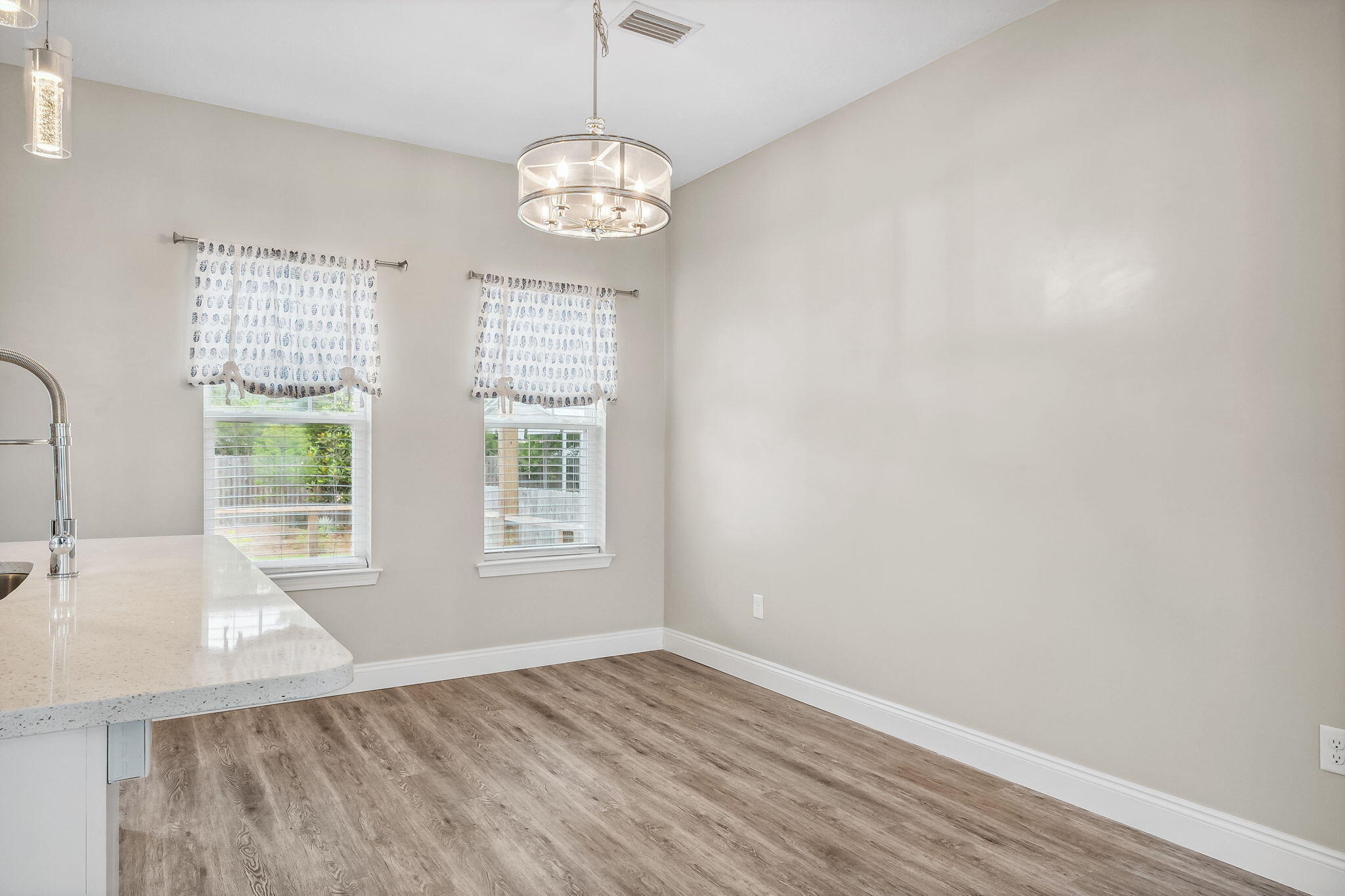 275 Indian Woman Road Santa Rosa Beach, FL 32459 - Photo 15 of 41 a view of an empty room with wooden floor and a window