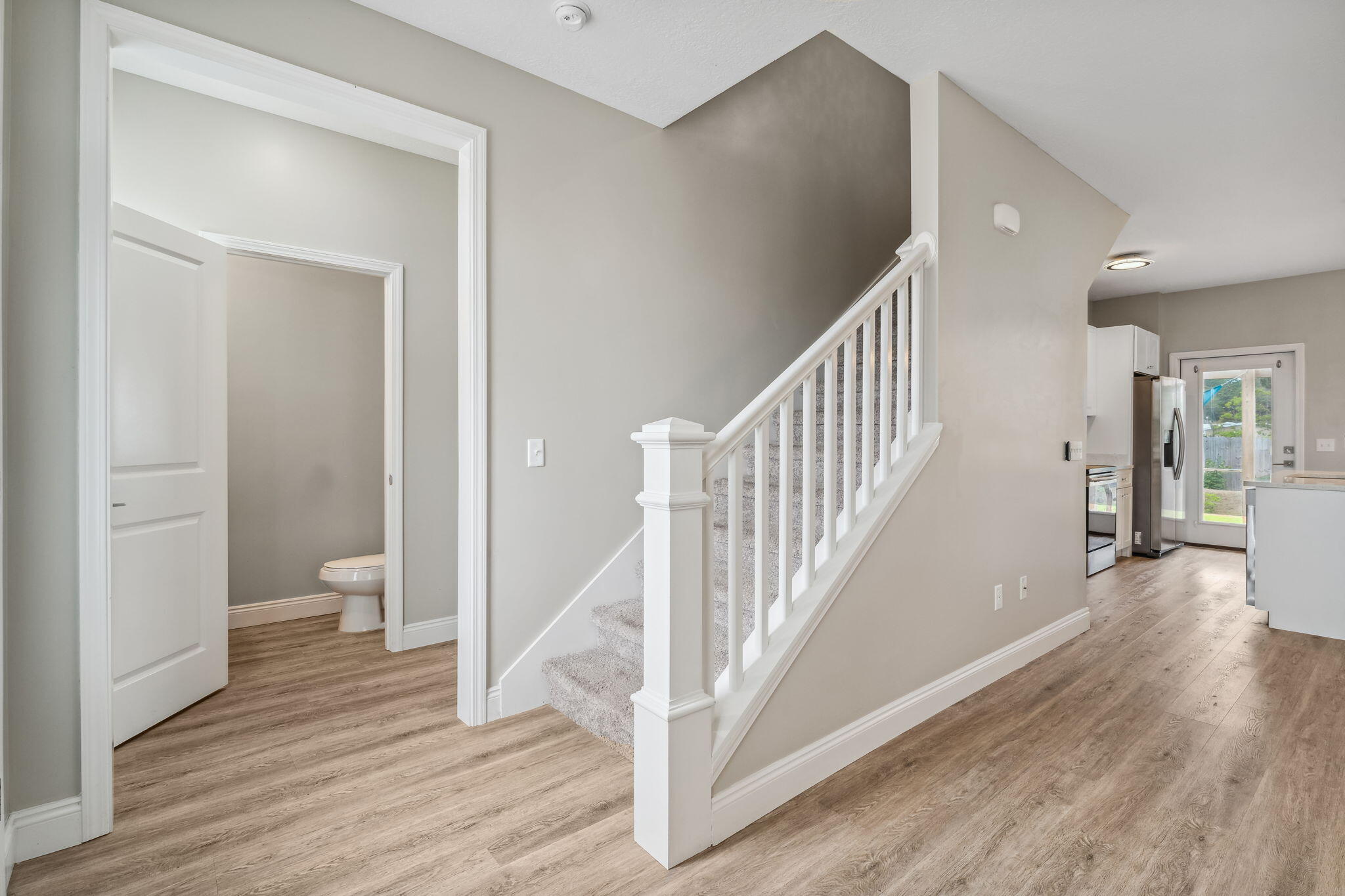 275 Indian Woman Road Santa Rosa Beach, FL 32459 - Photo 20 of 41 a view of a hallway with wooden floor and a bathroom