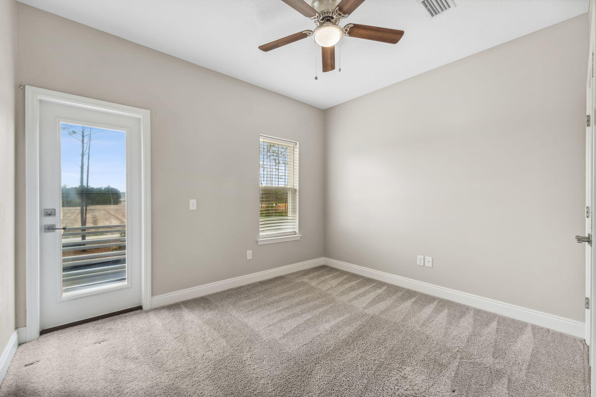 275 Indian Woman Road Santa Rosa Beach, FL 32459 - Photo 24 of 41 an empty room with windows and fan