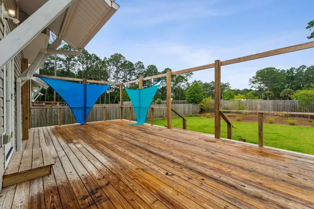 a view of a wooden deck front of house