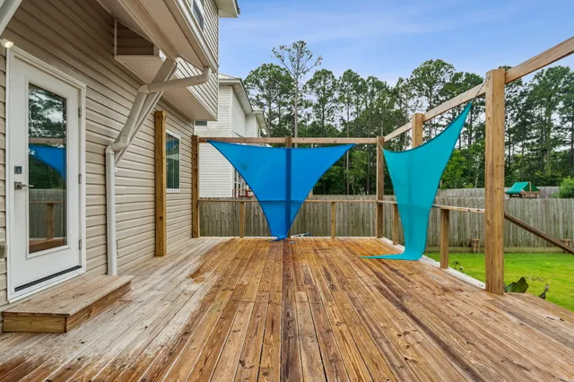 a view of backyard with a deck and wooden floor