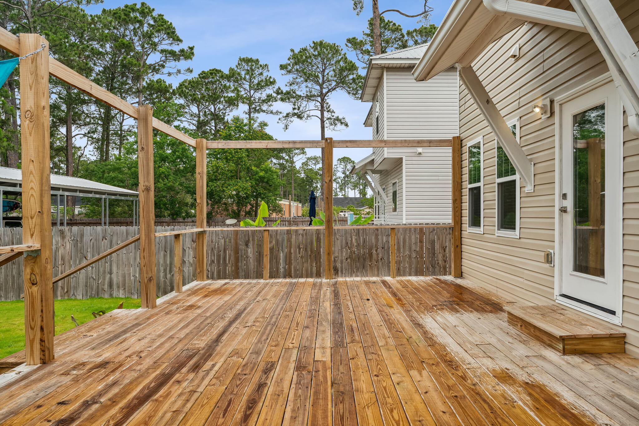 275 Indian Woman Road Santa Rosa Beach, FL 32459 - Photo 37 of 41 a view of backyard with a deck and wooden floor