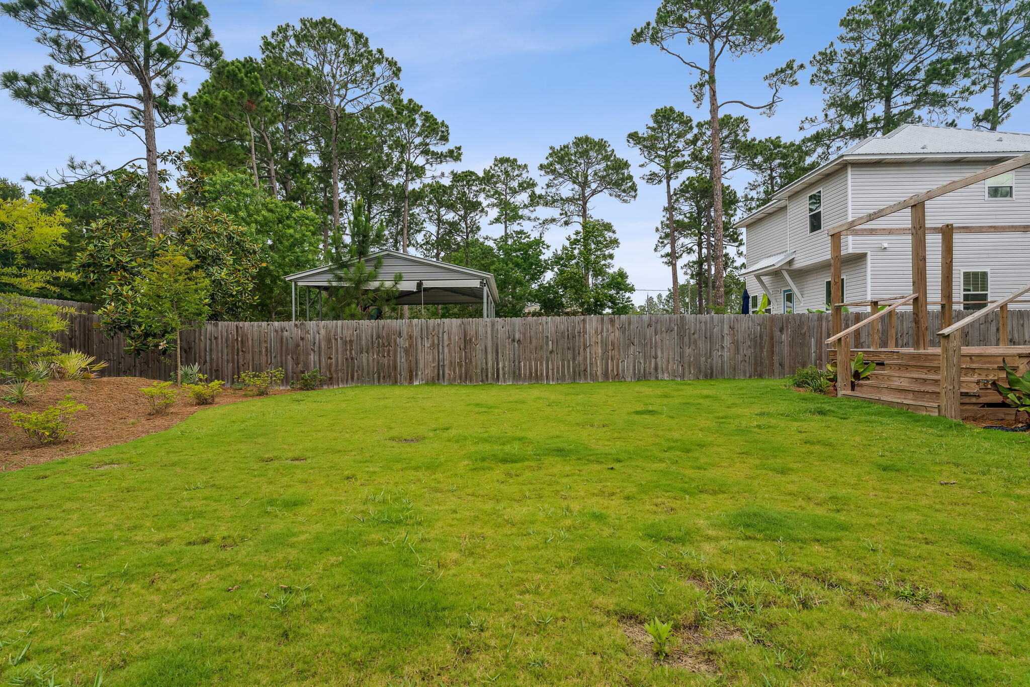 275 Indian Woman Road Santa Rosa Beach, FL 32459 - Photo 40 of 41 a view of a backyard with a garden