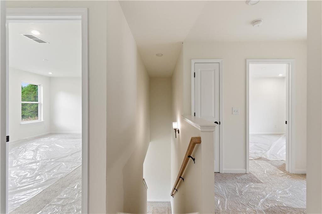 373 Waterbluff Drive Southwest Mableton, GA 30126 - Photo 12 of 21 a view of a hallway with paintings on the wall