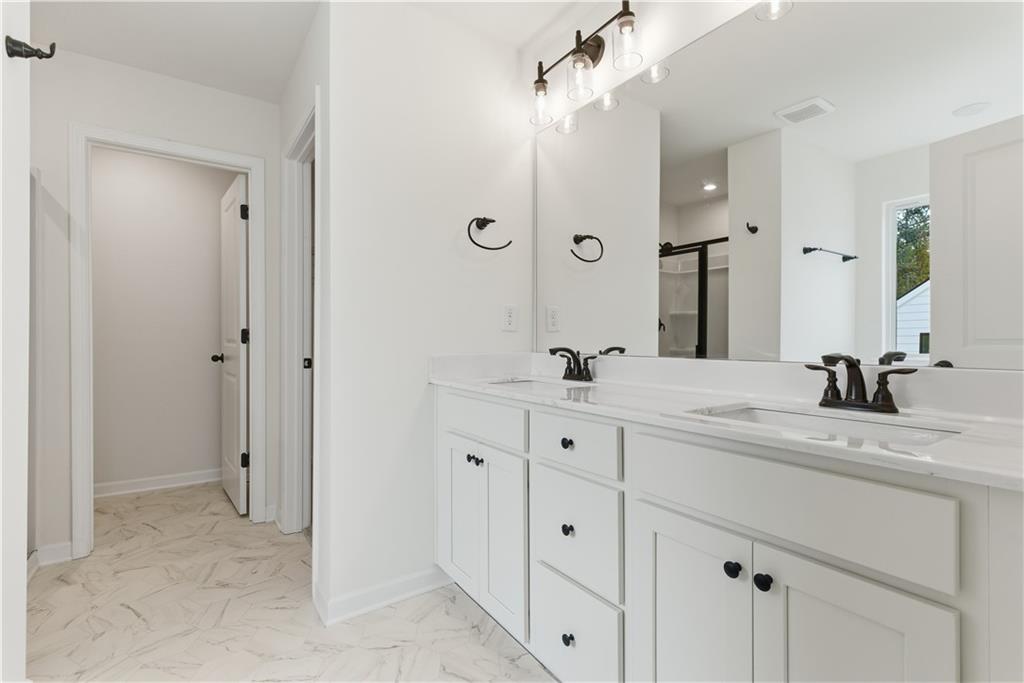 373 Waterbluff Drive Southwest Mableton, GA 30126 - Photo 14 of 21 a bathroom with double sink and a mirror