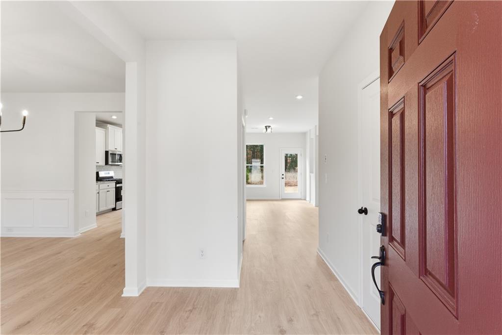 373 Waterbluff Drive Southwest Mableton, GA 30126 - Photo 2 of 21 wooden floor in a hall with an entryway