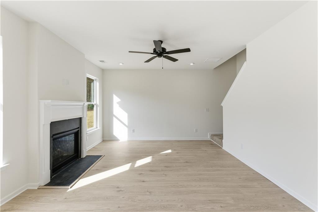 373 Waterbluff Drive Southwest Mableton, GA 30126 - Photo 9 of 21 an empty room with fireplace and fan