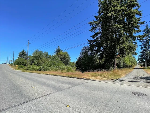 a view of a street with a house in background
