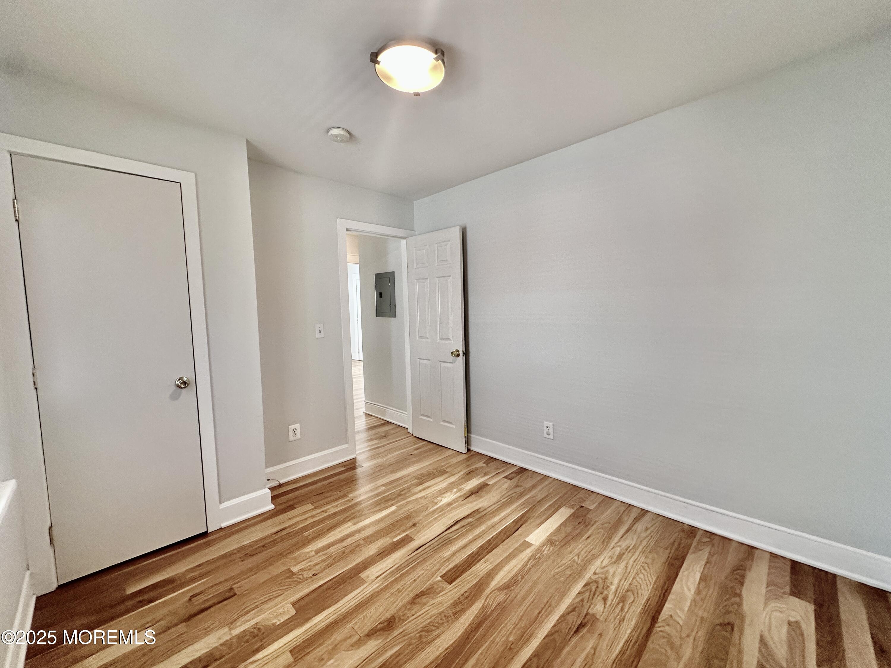 1004 5th Avenue, Unit 1N Asbury Park, NJ 07712 - Photo 8 of 14 a view of room with wooden floor