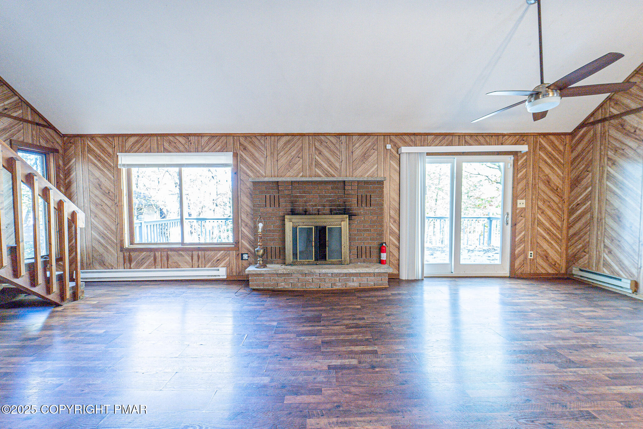 1562 Oak Lane Bushkill, PA 18324 - Photo 16 of 27 a view of an empty room with wooden floor fireplace and a window