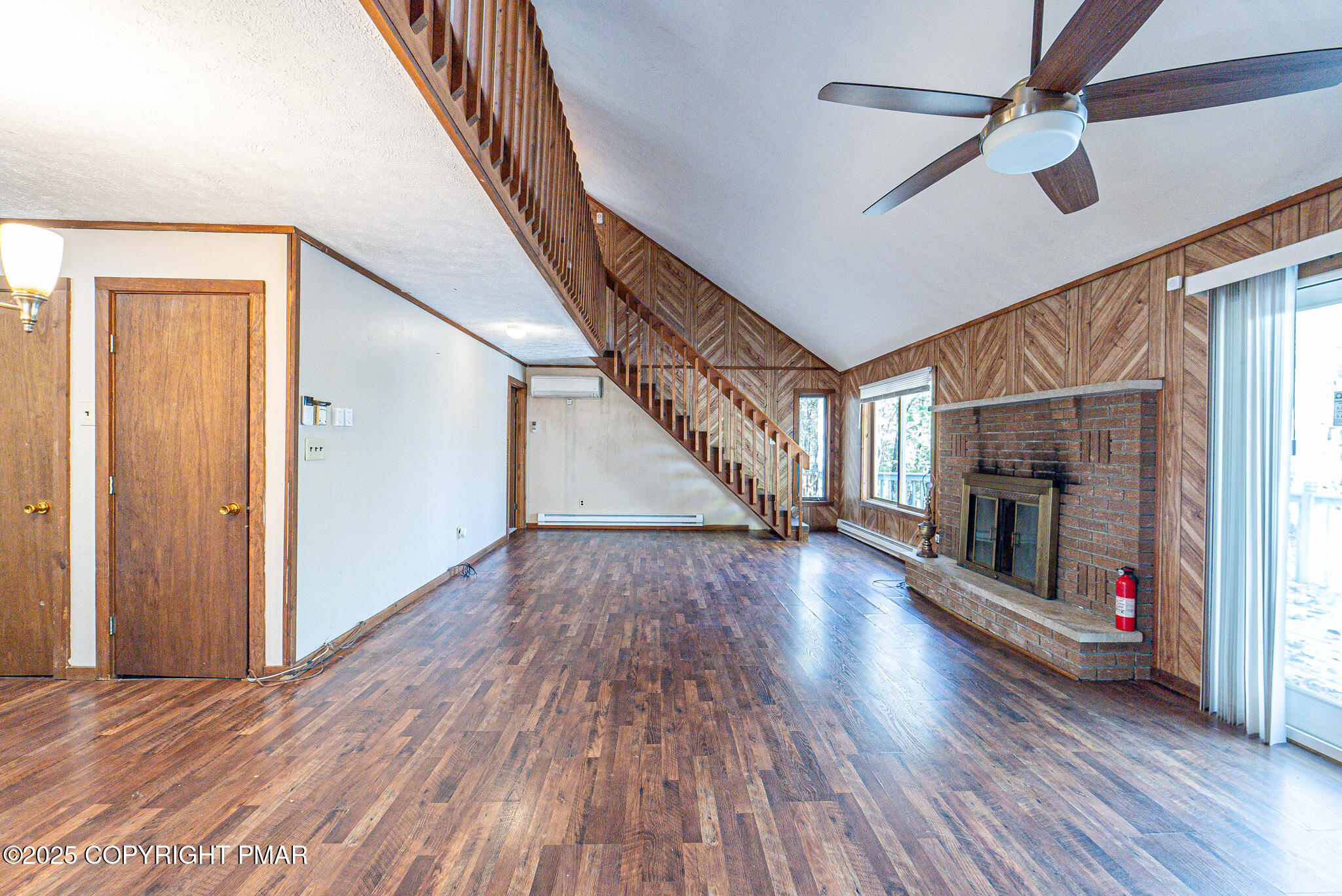 1562 Oak Lane Bushkill, PA 18324 - Photo 2 of 27 a view of an empty room with wooden floor fireplace and a window