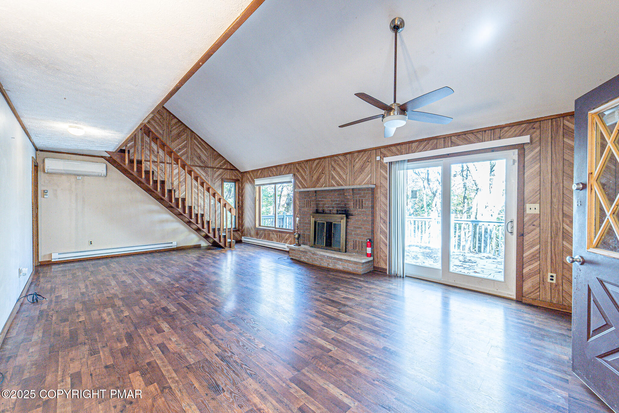 1562 Oak Lane Bushkill, PA 18324 - Photo 3 of 27 a view of an empty room with wooden floor fireplace and a window