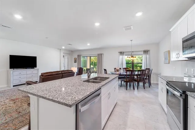 a kitchen with granite countertop a table and chairs