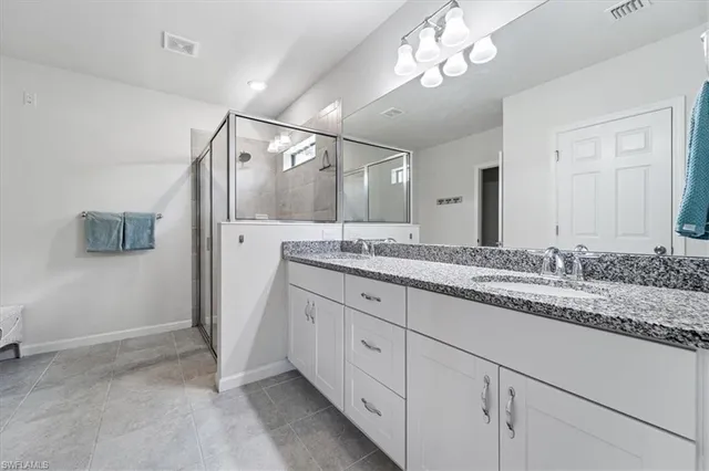 a bathroom with a sink double vanity and a mirror