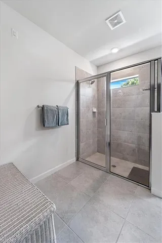 a bathroom with a shower and a glass door