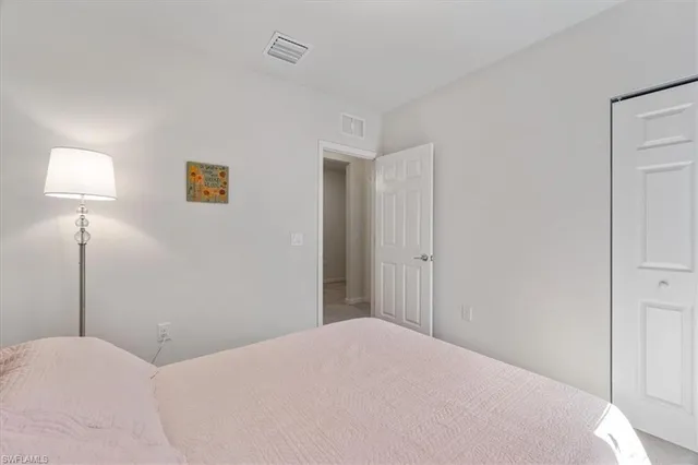 a bedroom with a bed and a lamp