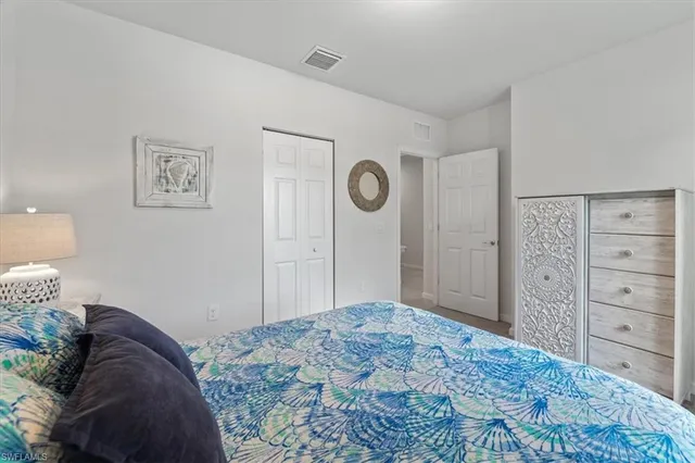 a bedroom with a bed and a cabinets