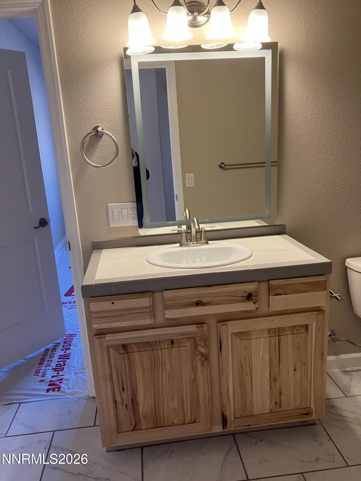 5 Pit Road Wellington, NV 89444 - Photo 11 of 38 a bathroom with a sink and a mirror