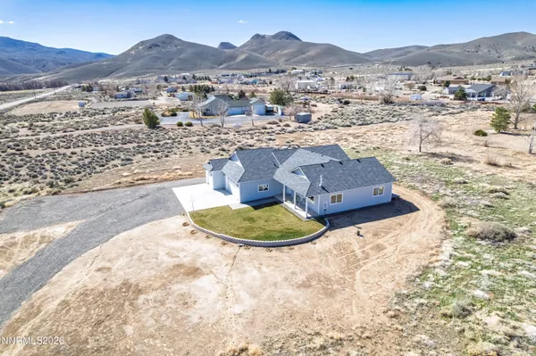 a front view of a house with a mountain