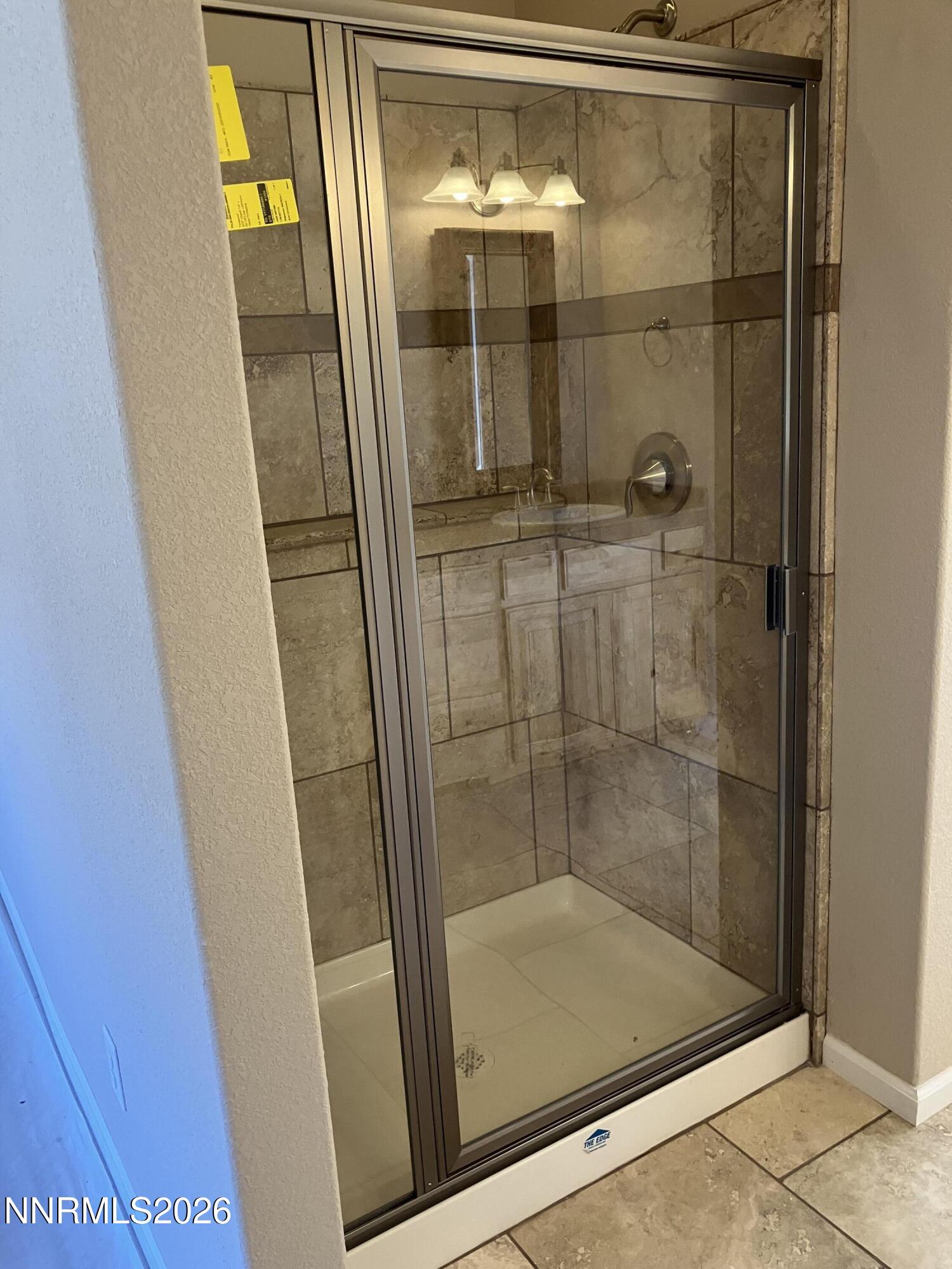 5 Pit Road Wellington, NV 89444 - Photo 14 of 38 a bathroom with a glass shower door