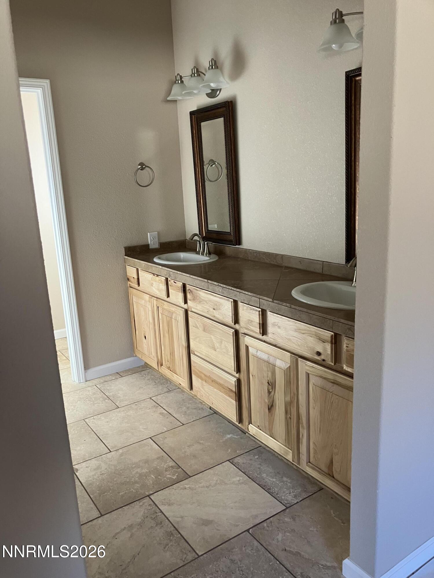 5 Pit Road Wellington, NV 89444 - Photo 17 of 38 a bathroom with a sink a toilet and mirror