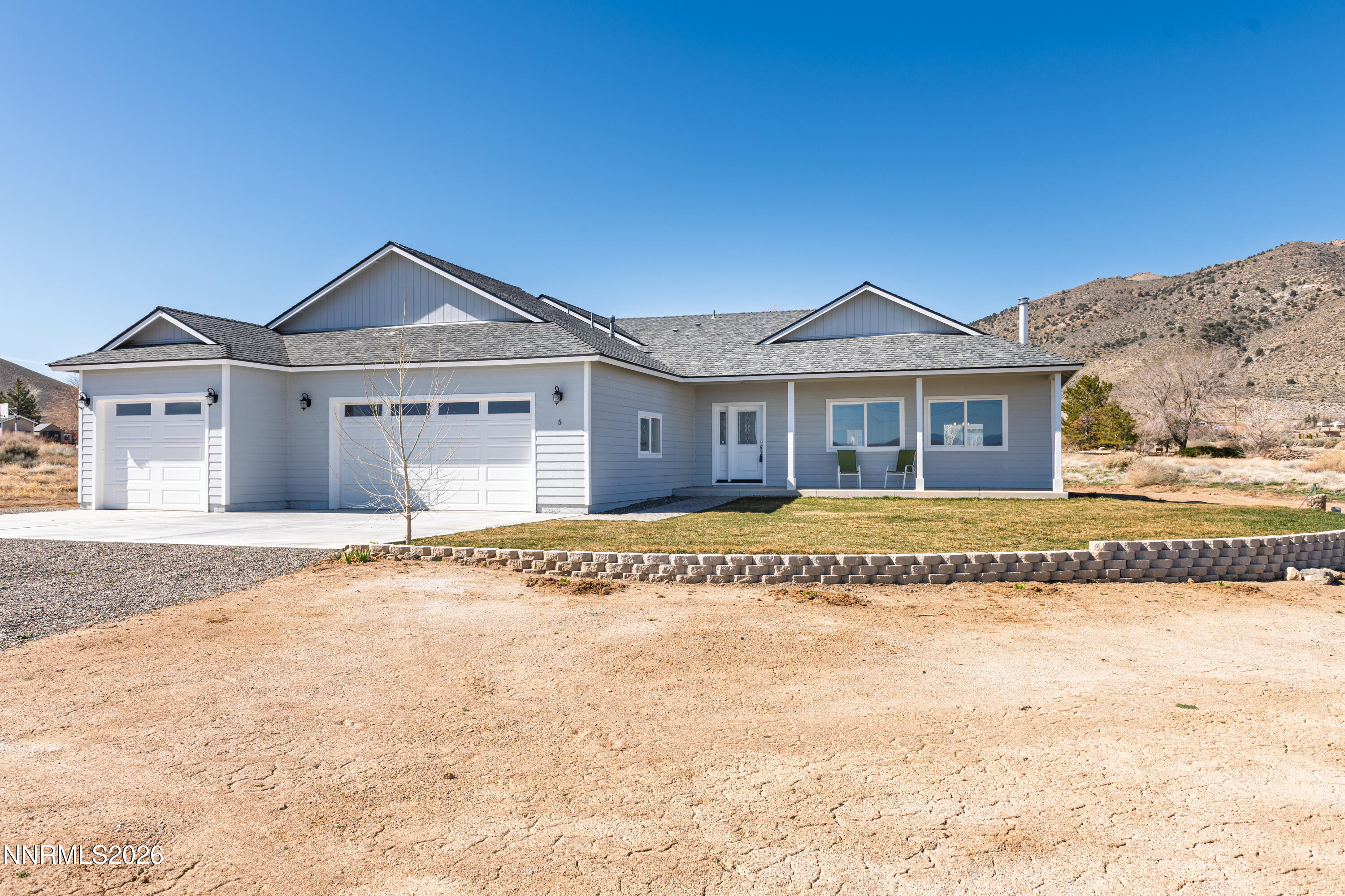 5 Pit Road Wellington, NV 89444 - Photo 2 of 51 a front view of a house with a yard