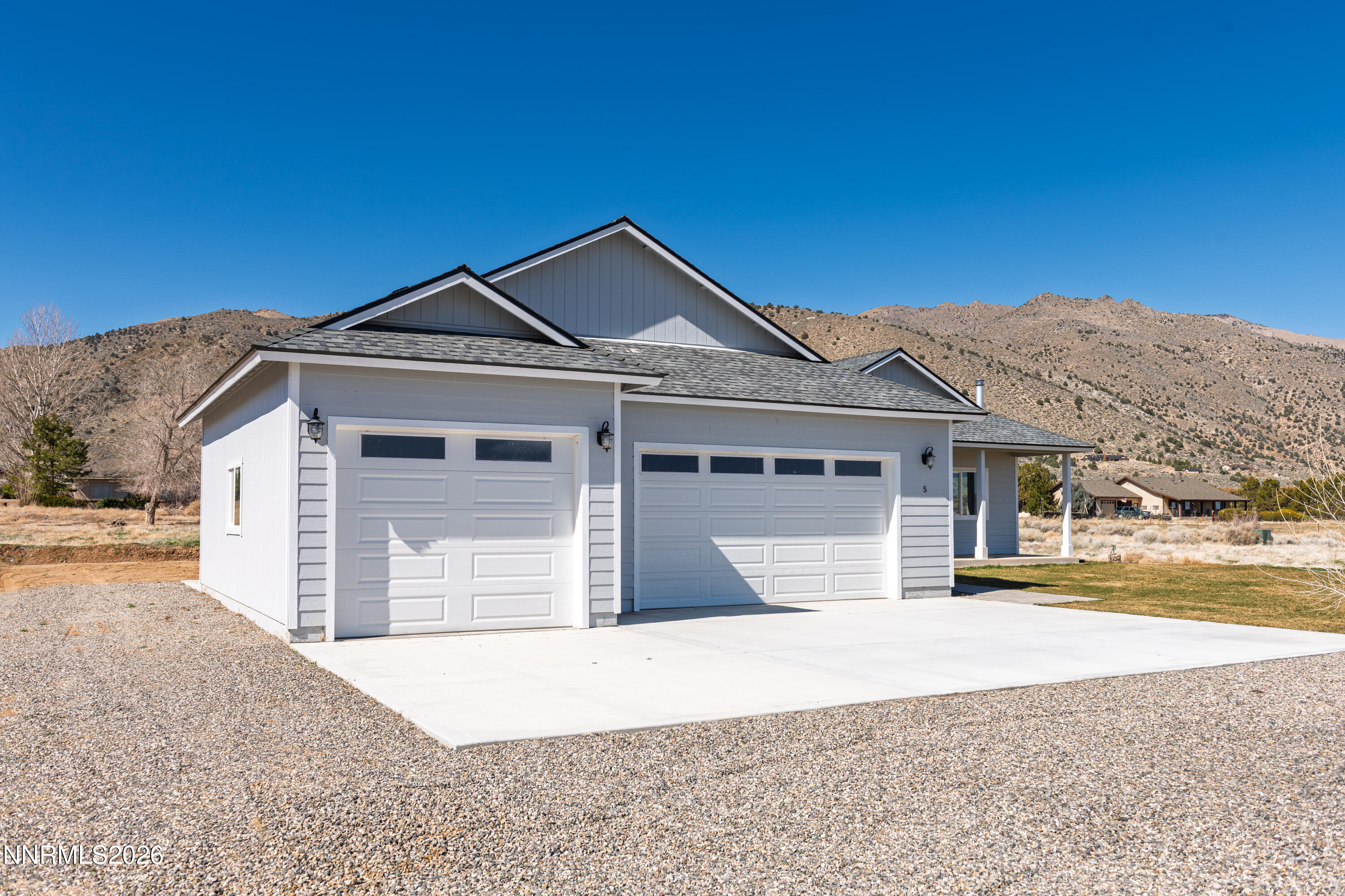 5 Pit Road Wellington, NV 89444 - Photo 23 of 51 a front view of a house with a yard and garage