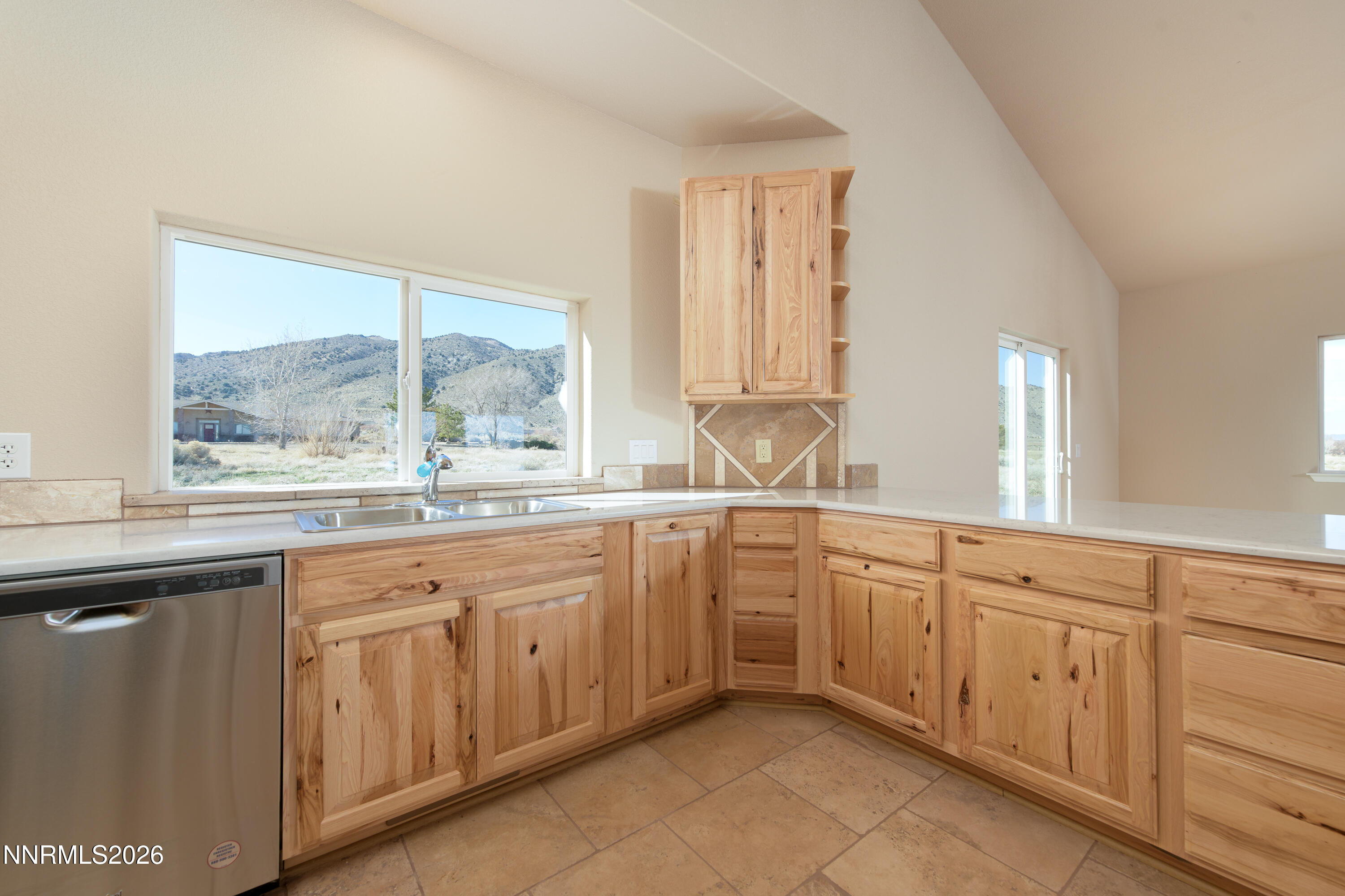 5 Pit Road Wellington, NV 89444 - Photo 32 of 51 a kitchen with granite countertop white cabinets white appliances with a sink and dishwasher