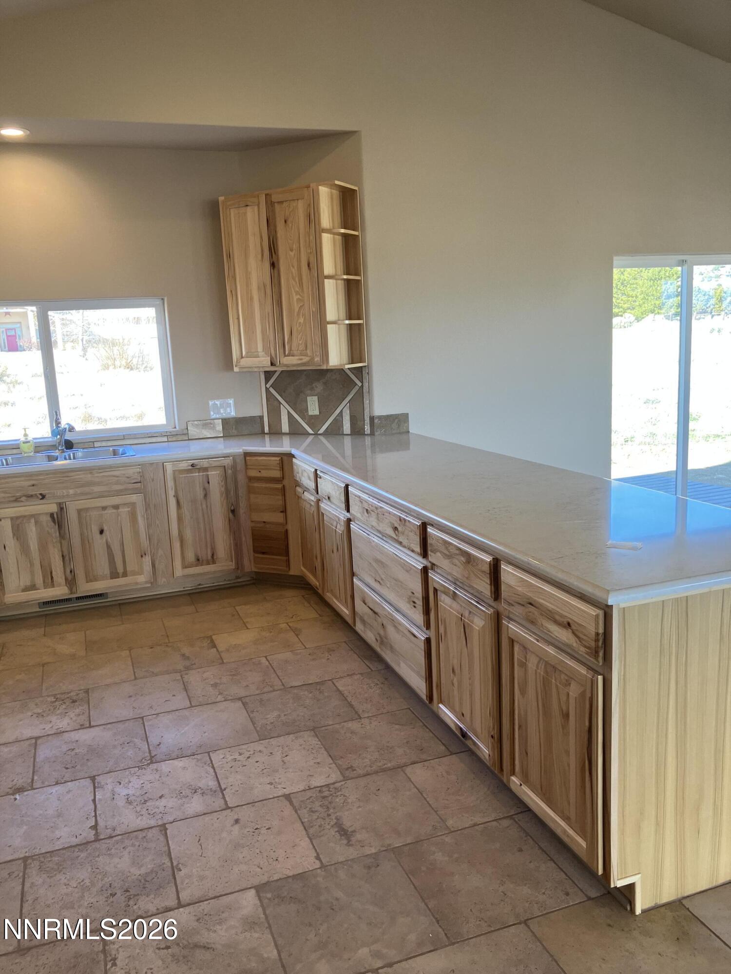5 Pit Road Wellington, NV 89444 - Photo 33 of 38 a large kitchen with stainless steel appliances granite countertop a sink and cabinets