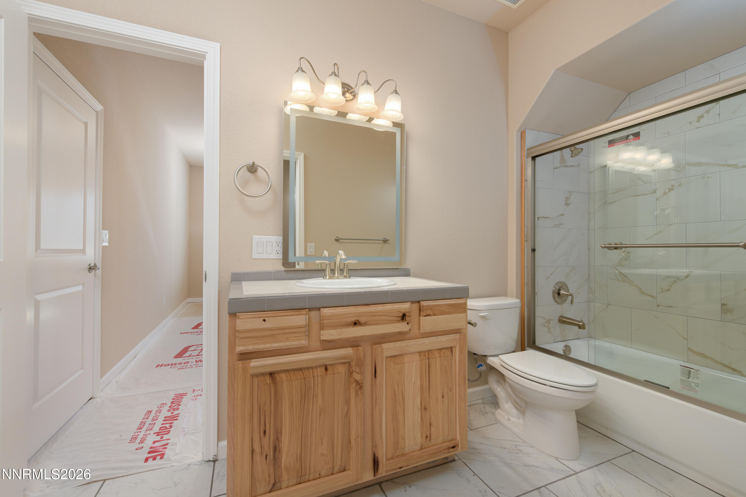 5 Pit Road Wellington, NV 89444 - Photo 39 of 51 a bathroom with a granite countertop toilet a sink and a mirror