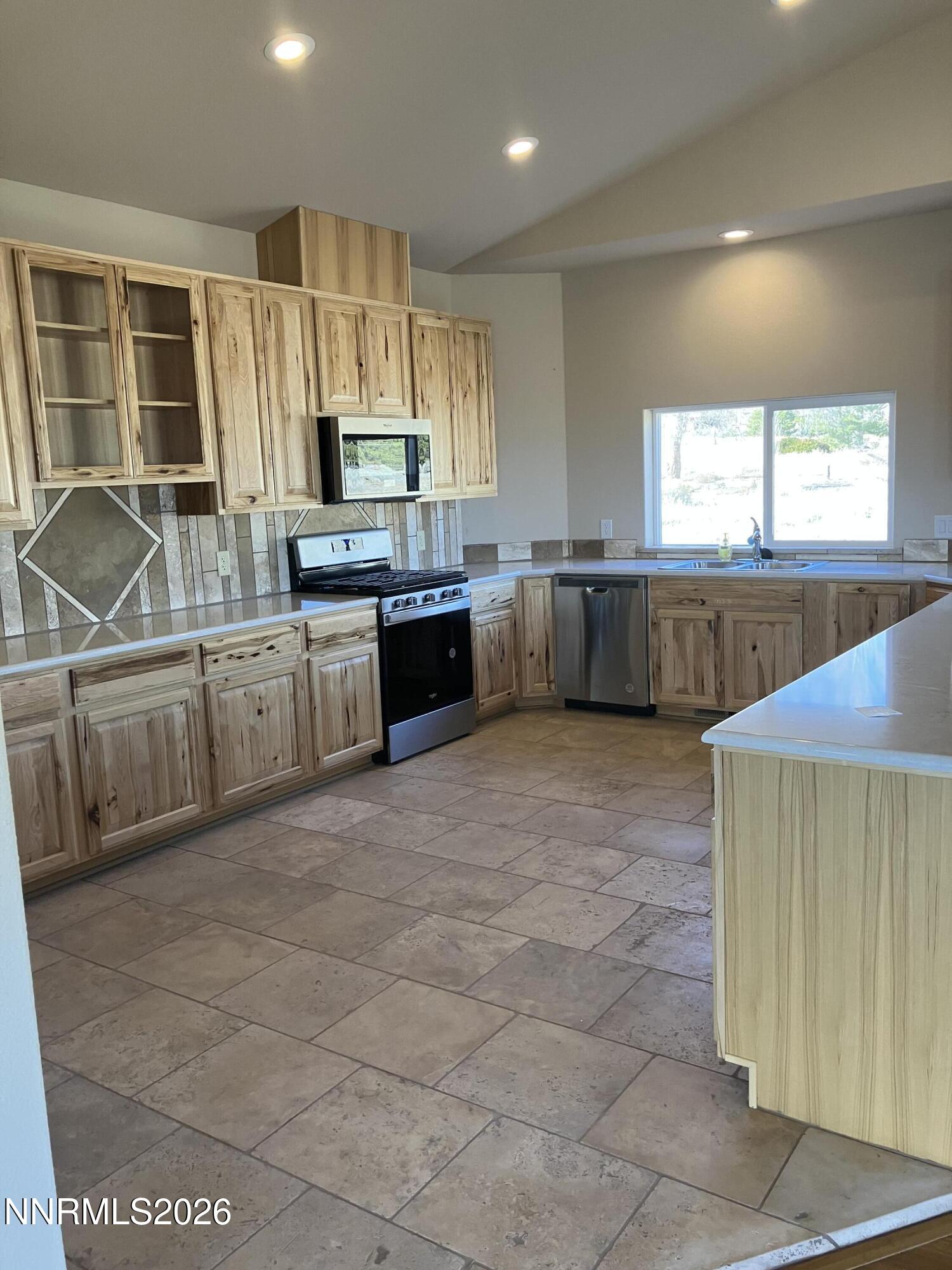 5 Pit Road Wellington, NV 89444 - Photo 5 of 38 a large kitchen with a large counter top cabinets appliances and a window