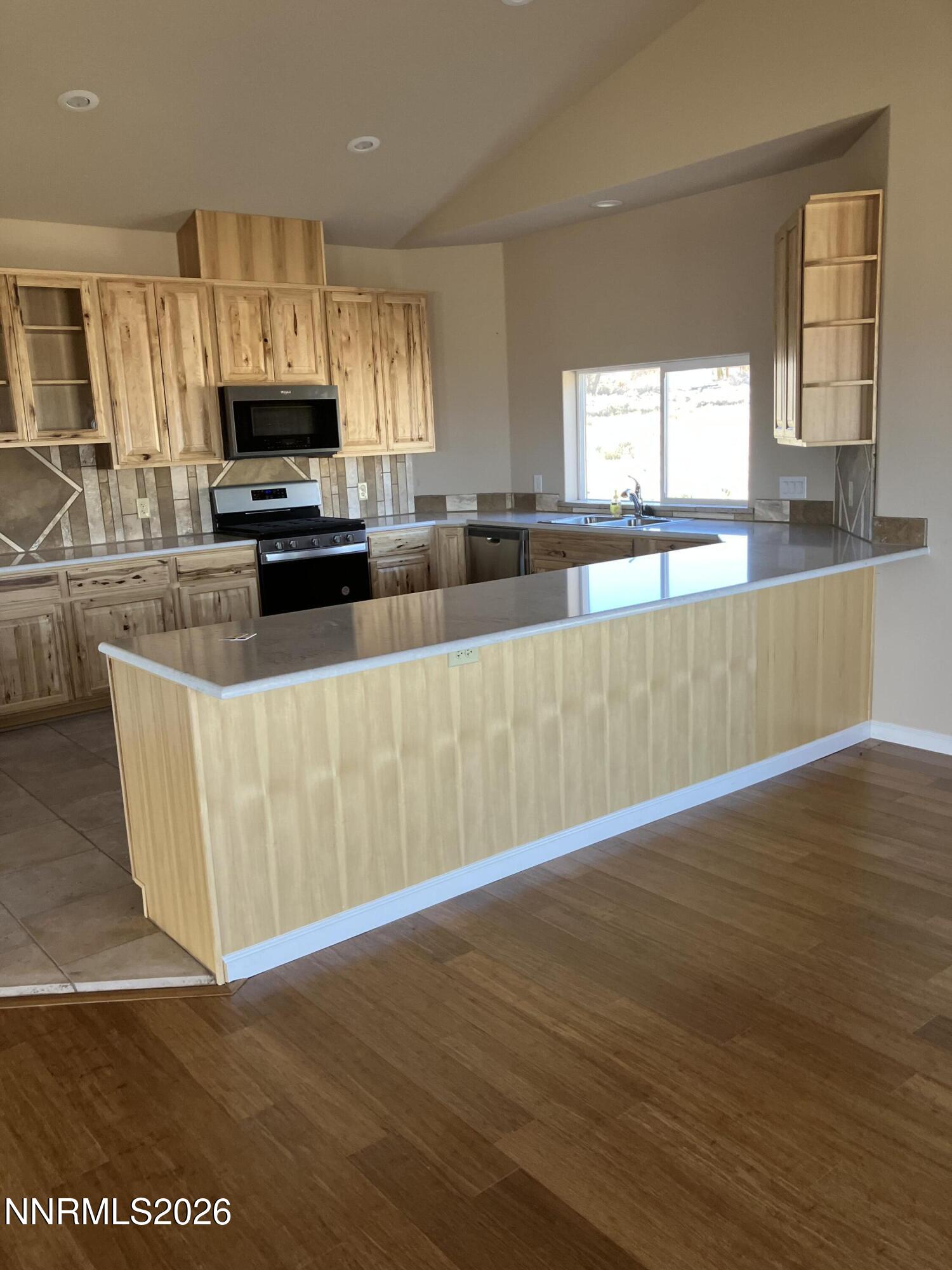 5 Pit Road Wellington, NV 89444 - Photo 6 of 38 a view of a kitchen with wooden floor and electronic appliances