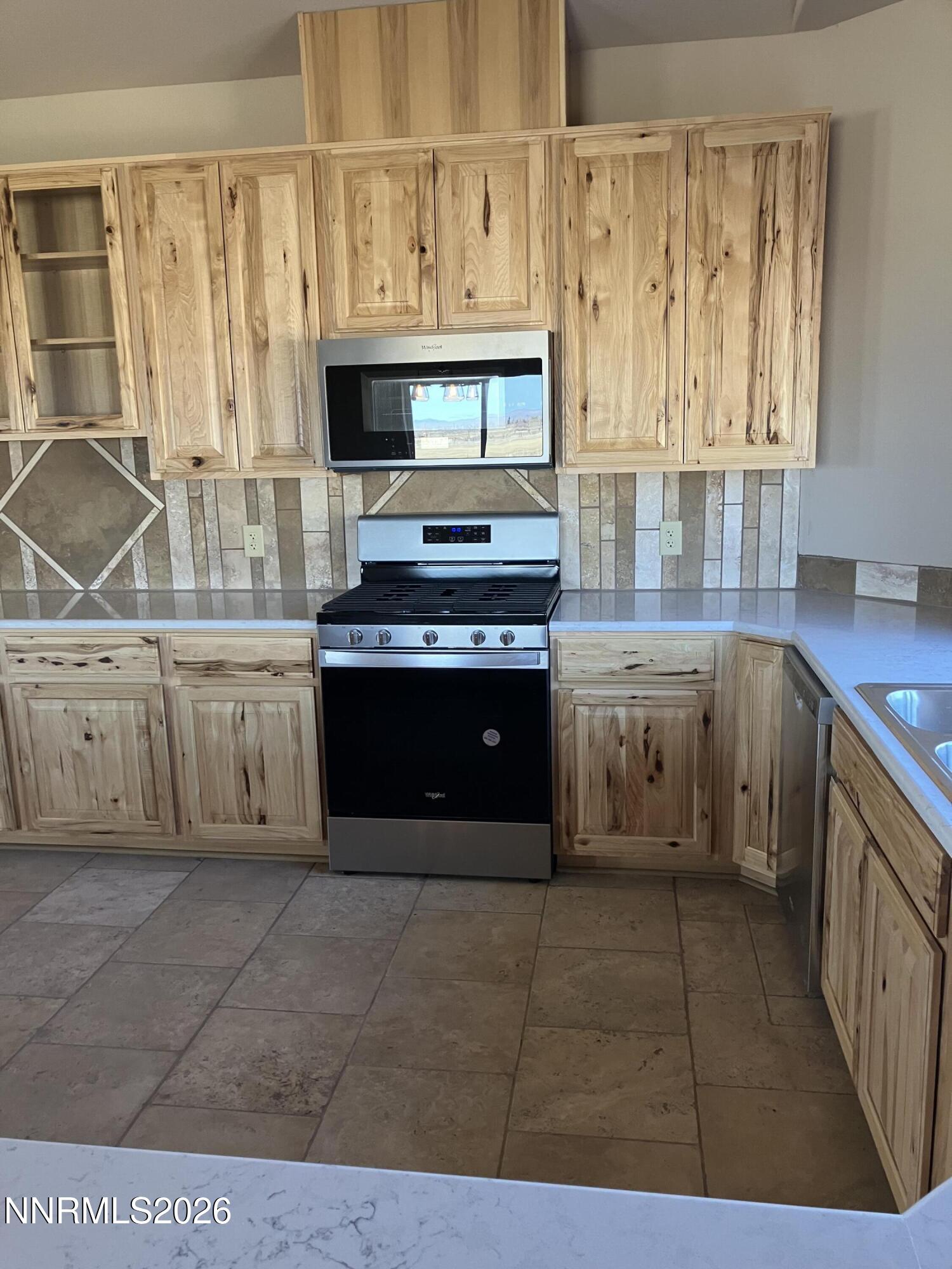5 Pit Road Wellington, NV 89444 - Photo 8 of 38 a kitchen with stainless steel appliances a stove and a sink