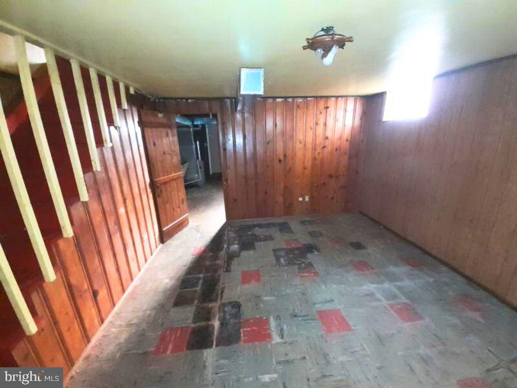 5619 Wesley Avenue Baltimore, MD 21207 - Photo 12 of 29 wooden floor in an empty room with a window