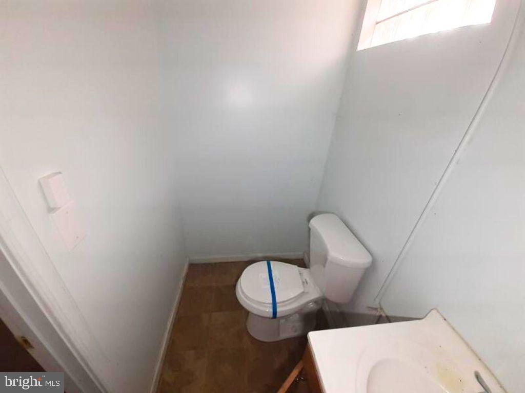 5619 Wesley Avenue Baltimore, MD 21207 - Photo 15 of 29 a bathroom with a toilet and sink