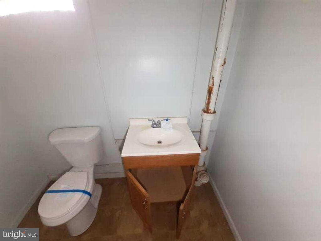 5619 Wesley Avenue Baltimore, MD 21207 - Photo 16 of 29 a bathroom with a toilet and a sink