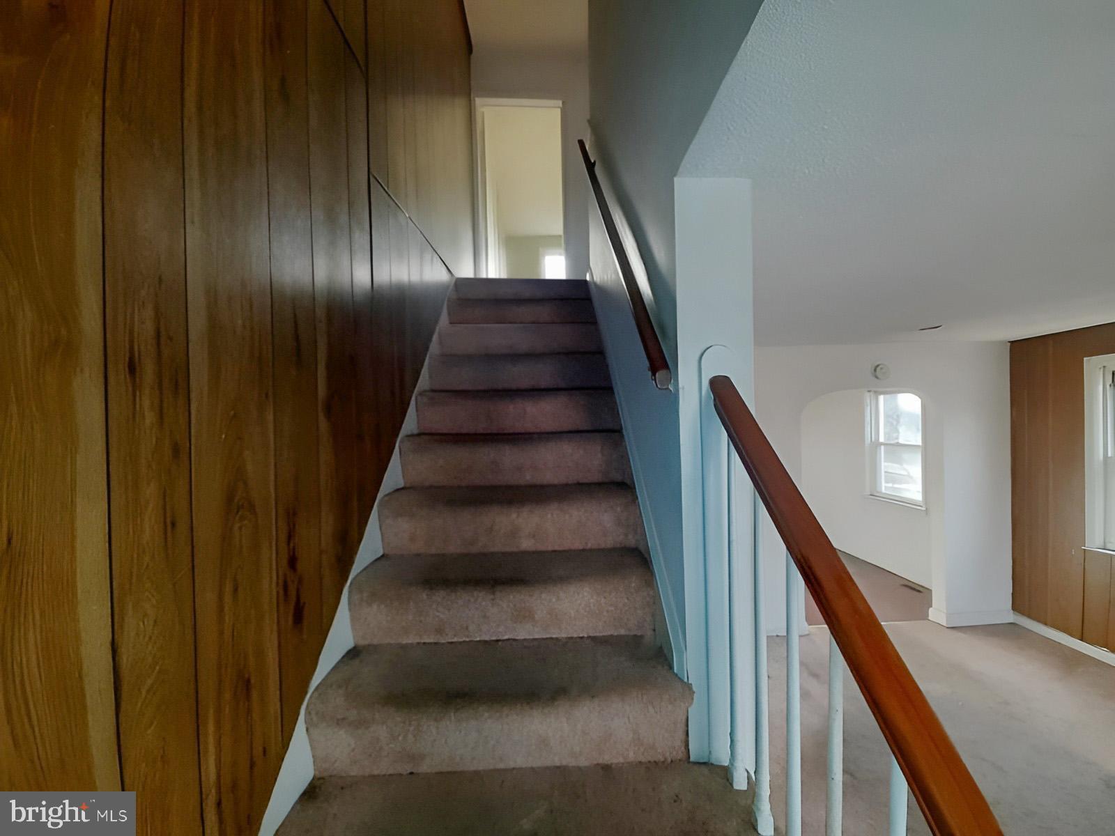5619 Wesley Avenue Baltimore, MD 21207 - Photo 20 of 39 a view of staircase with wooden floor and white walls