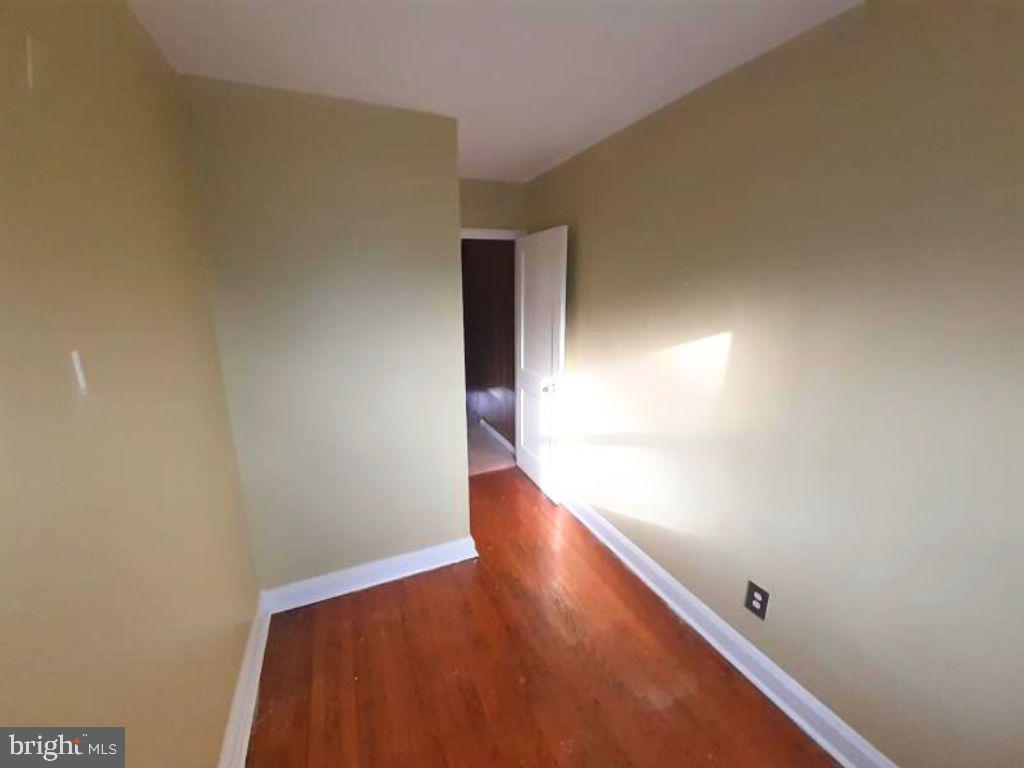 5619 Wesley Avenue Baltimore, MD 21207 - Photo 22 of 29 a view of a room with wooden floor