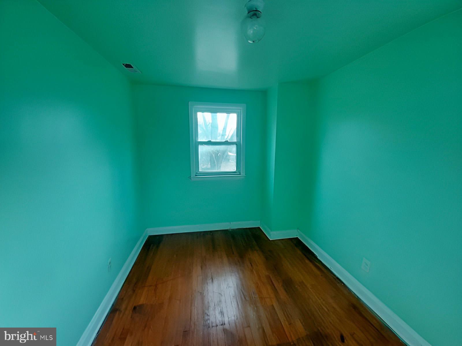 5619 Wesley Avenue Baltimore, MD 21207 - Photo 24 of 39 a view of a room that has wooden floor and windows
