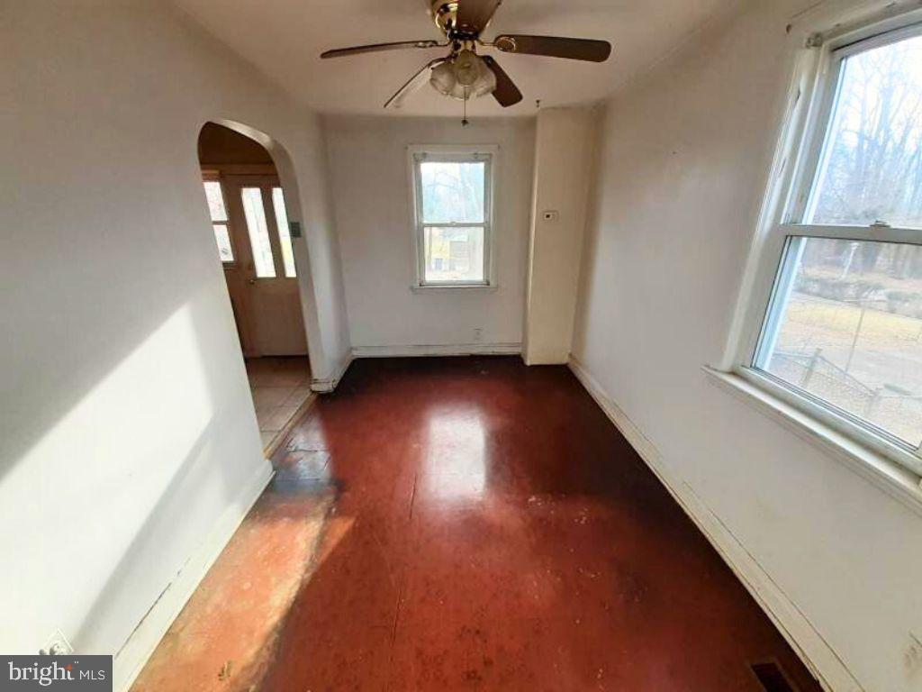 5619 Wesley Avenue Baltimore, MD 21207 - Photo 6 of 29 wooden floor in an empty room with a window