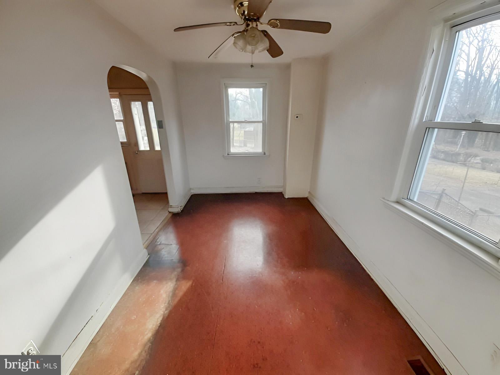 5619 Wesley Avenue Baltimore, MD 21207 - Photo 6 of 39 wooden floor in an empty room with a window