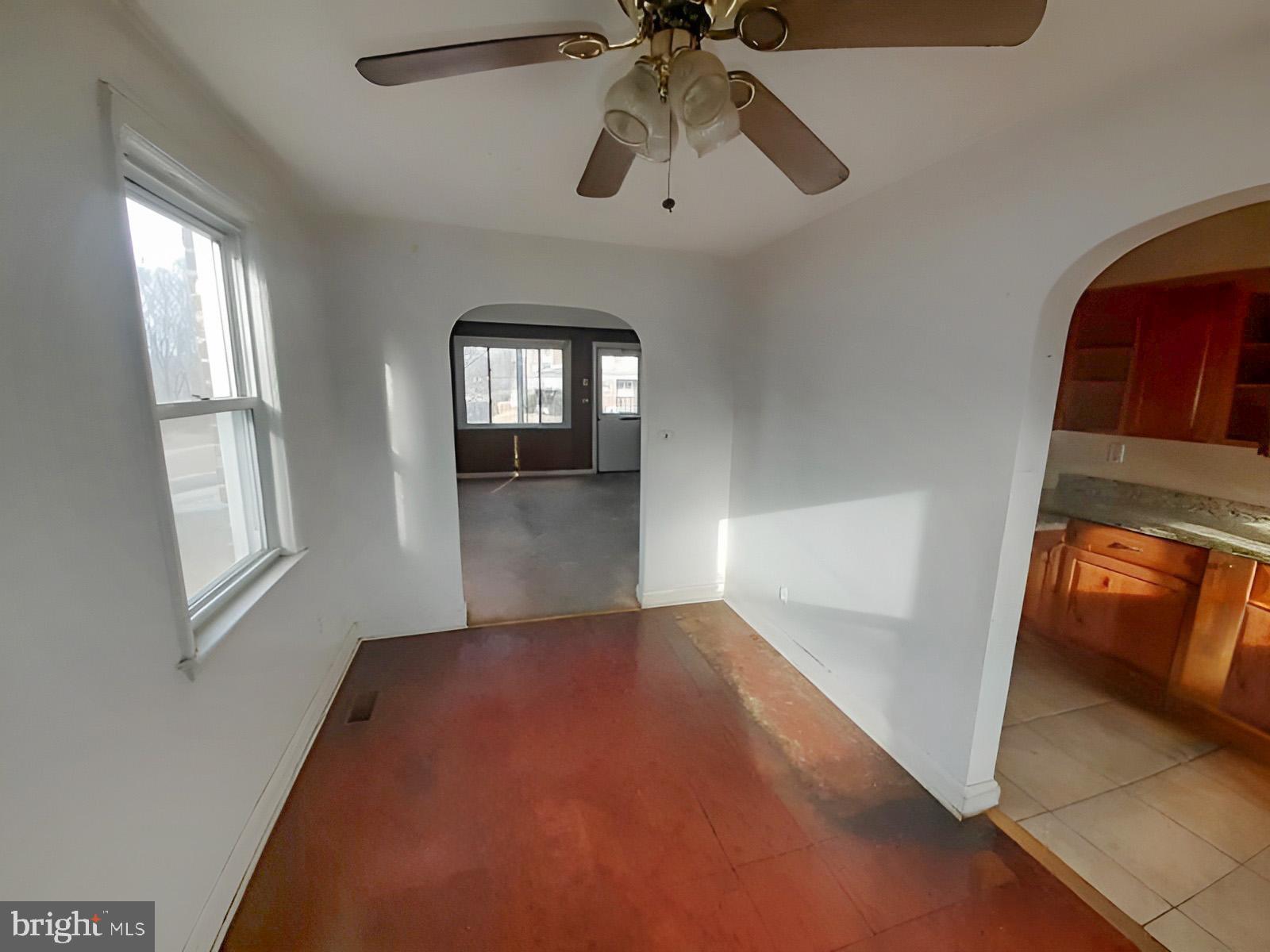 5619 Wesley Avenue Baltimore, MD 21207 - Photo 7 of 39 wooden floor in an empty room with a window