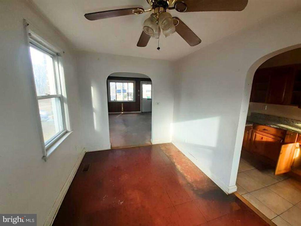 5619 Wesley Avenue Baltimore, MD 21207 - Photo 7 of 29 wooden floor in an empty room with a window