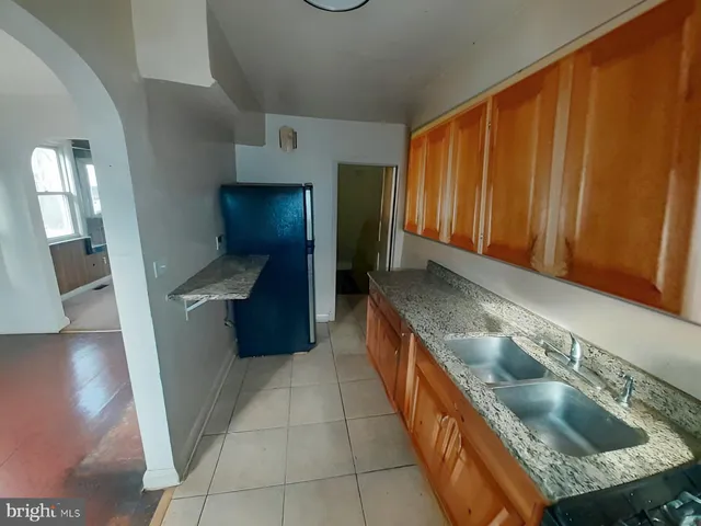 a kitchen with stainless steel appliances granite countertop a sink and a stove